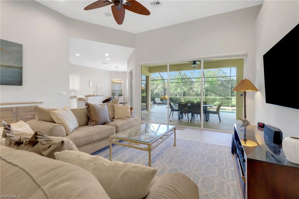 6757 Bent Grass Drive Naples, FL 34113 - Photo 7 of 27 a living room with furniture and a flat screen tv