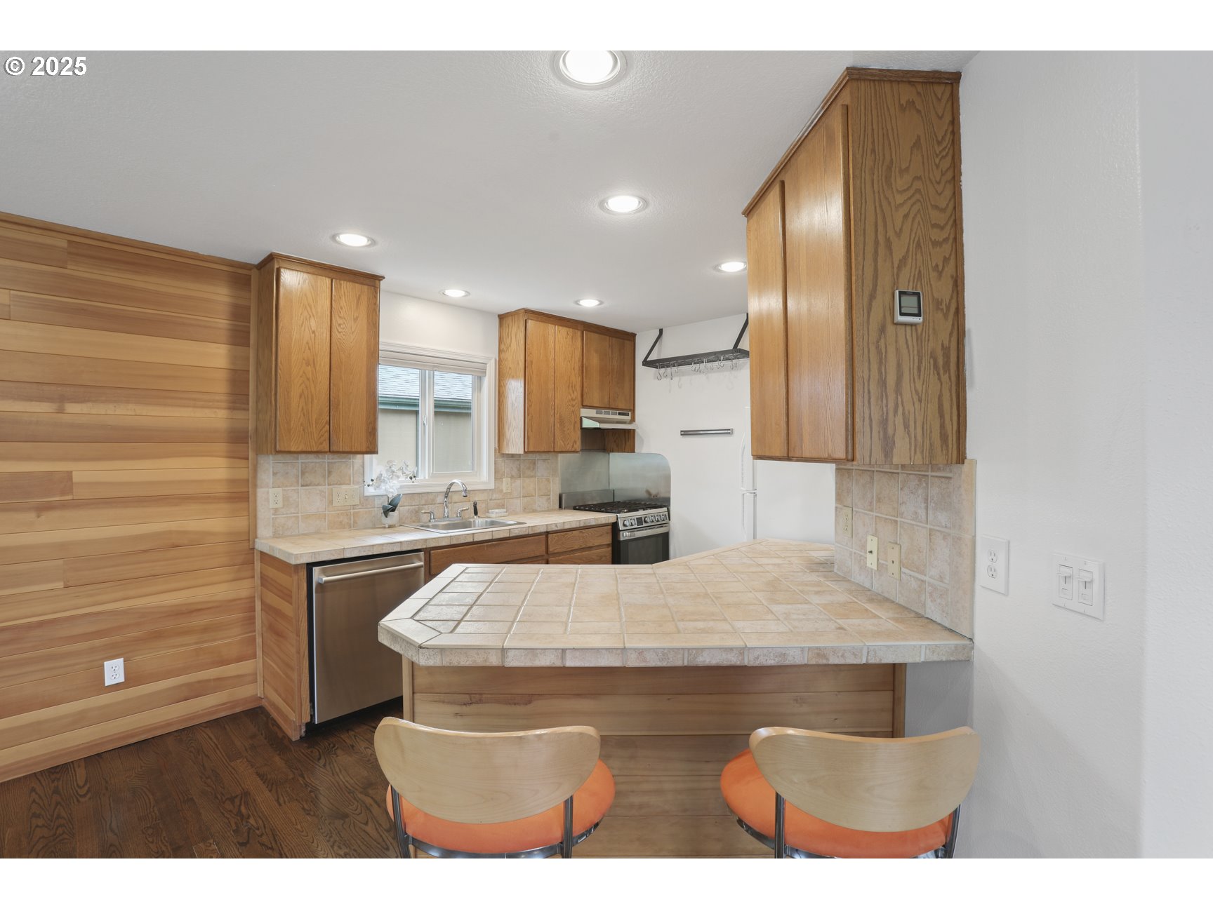 50776 Dike Road, Unit 4 Scappoose, OR 97056 - Photo 15 of 37 a kitchen with kitchen island granite countertop a stove a sink and a refrigerator