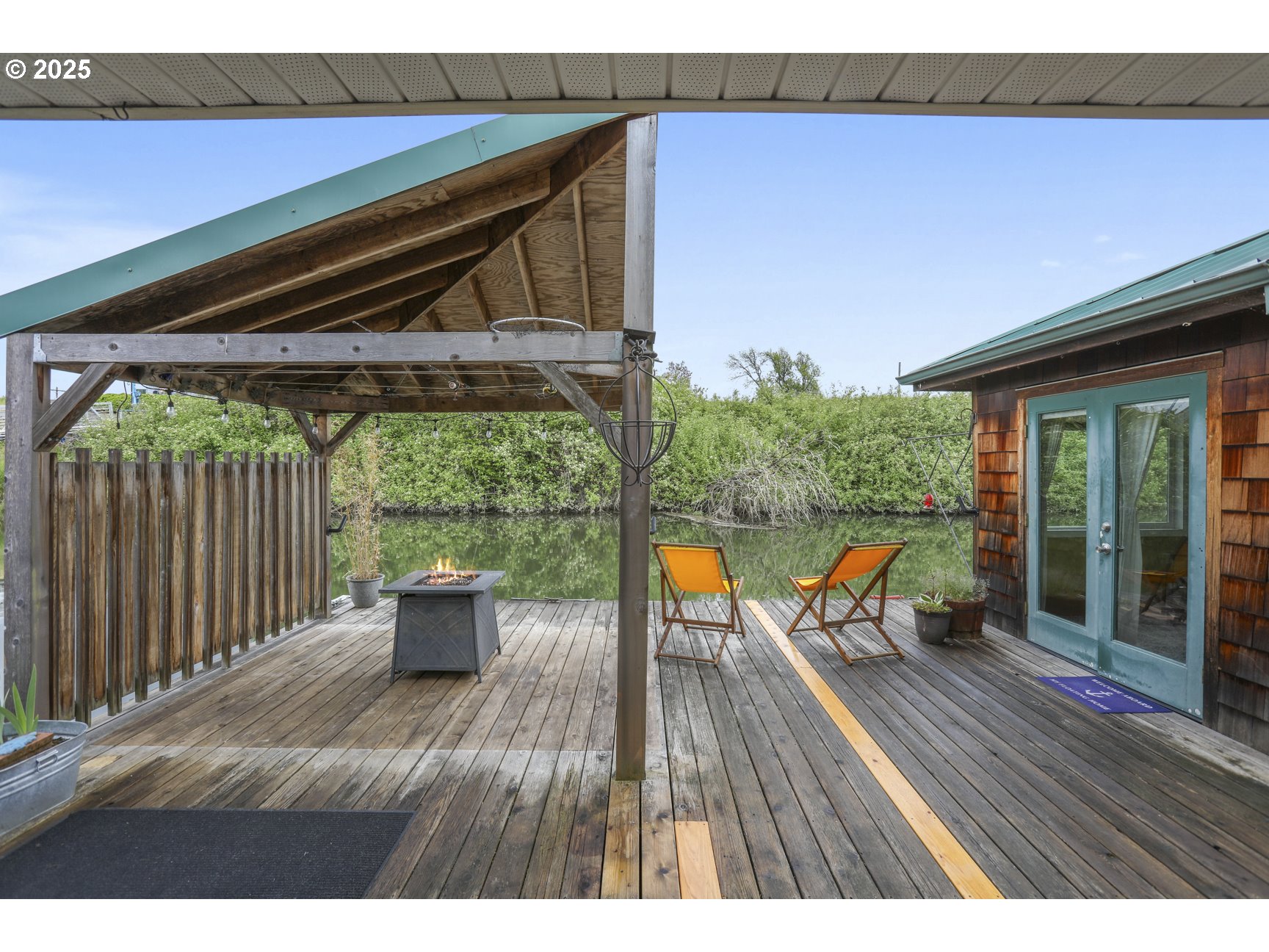 50776 Dike Road, Unit 4 Scappoose, OR 97056 - Photo 20 of 37 a balcony with wooden floor and outdoor seating