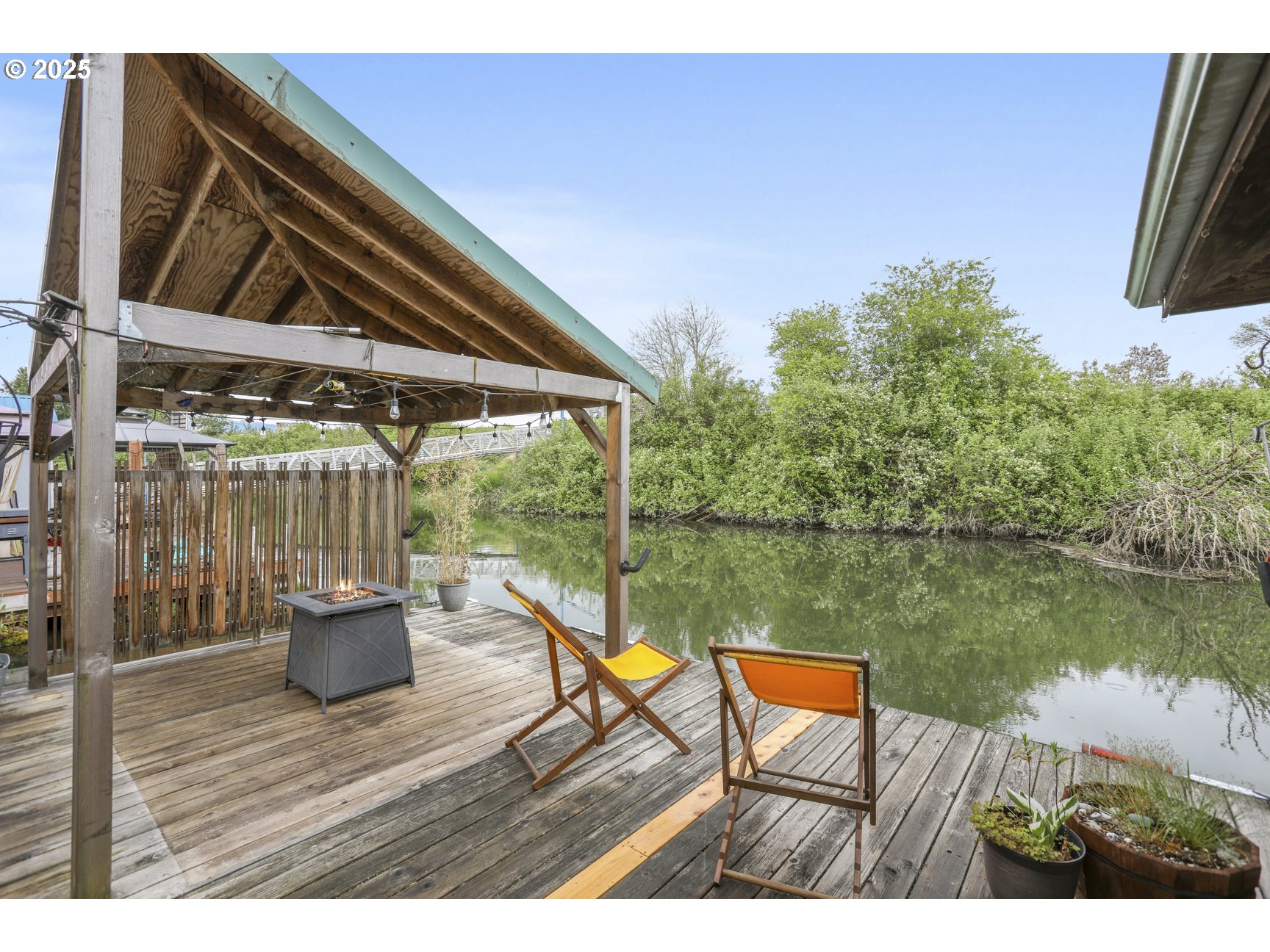 50776 Dike Road, Unit 4 Scappoose, OR 97056 - Photo 25 of 37 a backyard of a house with lake view and a potted plant