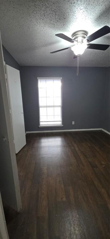 18333 Roehampton Drive, Unit 928 Dallas, TX 75252 - Photo 11 of 20 an empty room with wooden floor and windows