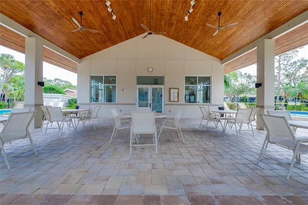 a outdoor space with lots of tables a chair and a fireplace