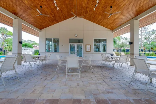 a outdoor space with lots of tables a chair and a fireplace