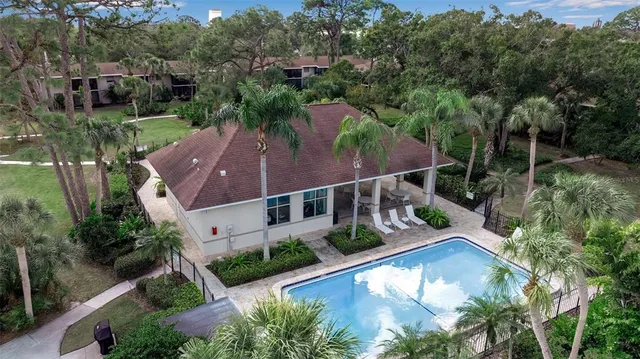 an aerial view of house with yard swimming pool and outdoor seating