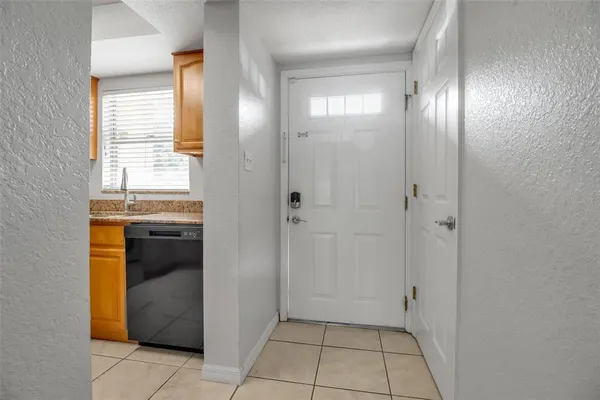 a view of an empty room with closet and a window
