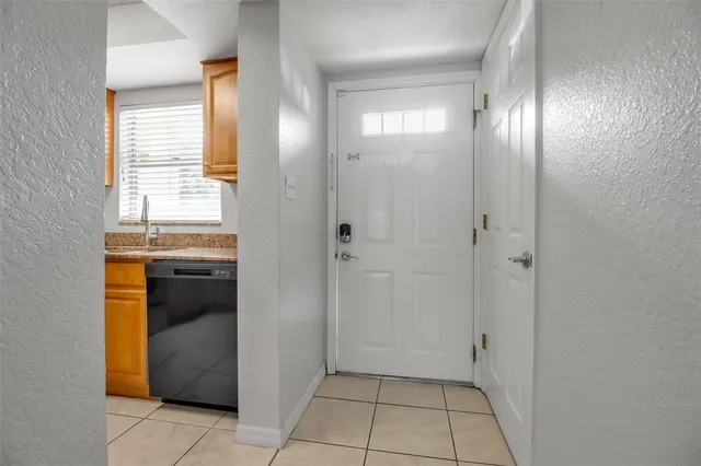 a view of an empty room with closet and a window