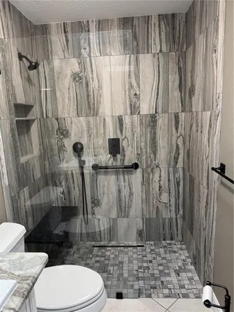 a bathroom with a toilet and a shower