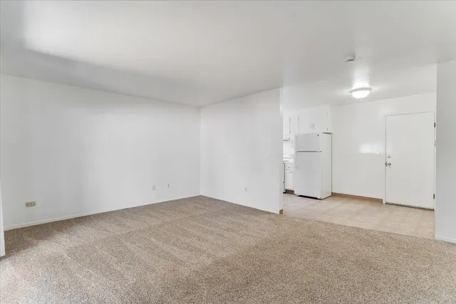 an empty room with an entryway and an empty room
