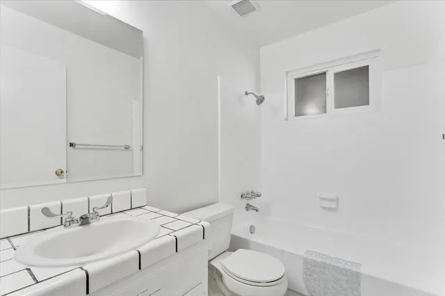 a bathroom with a toilet a sink and bathtub