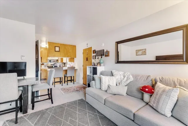 a living room with furniture and painting on the wall