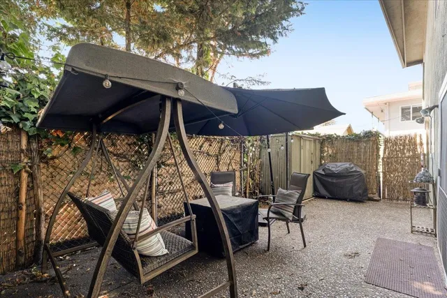 an outdoor space with furniture and umbrella