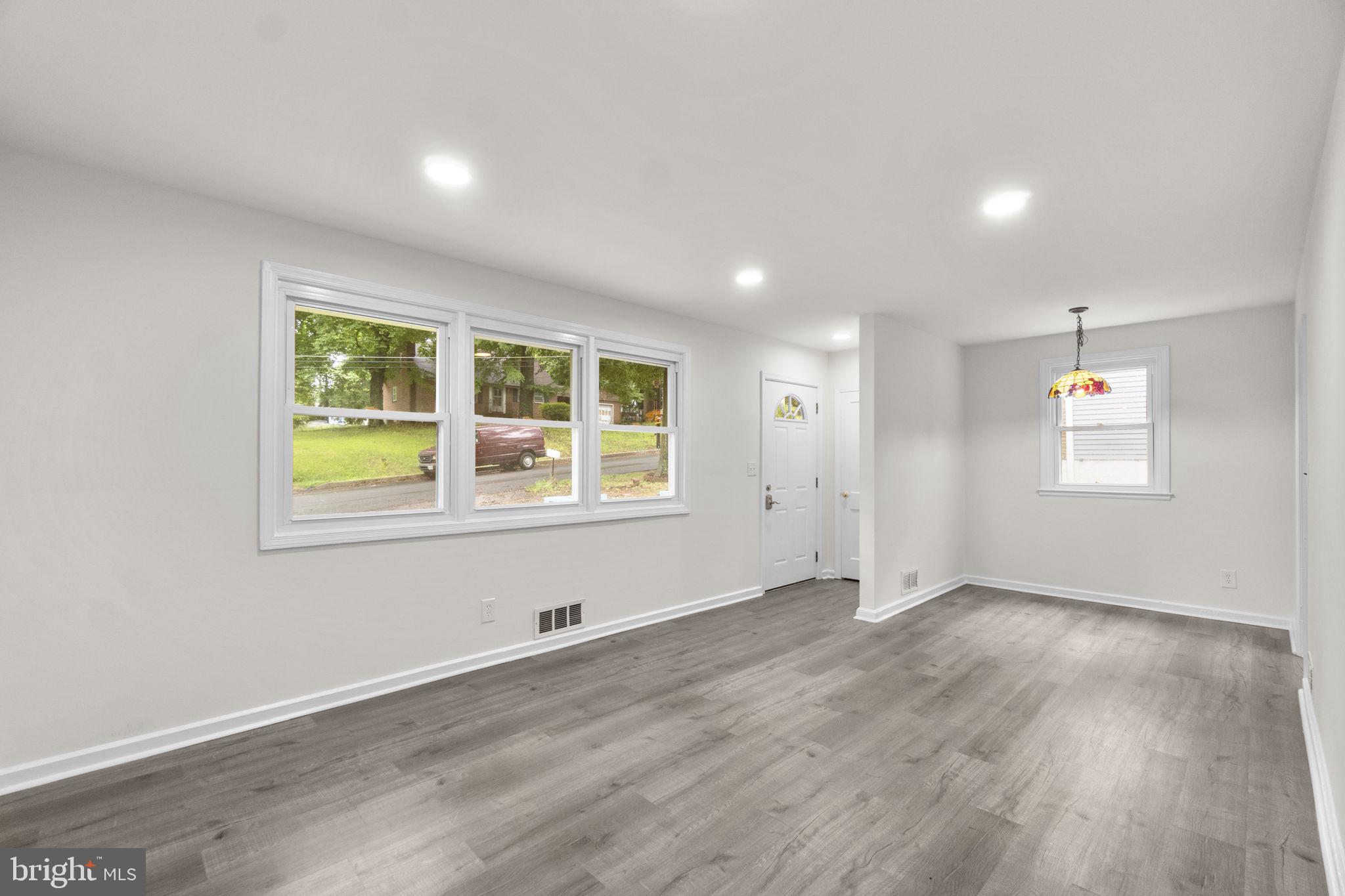 3658 Clifmar Road Baltimore, MD 21244 - Photo 12 of 43 an empty room with wooden floor and windows