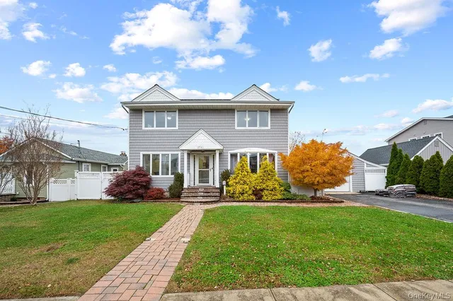 a front view of a house with a garden and plants