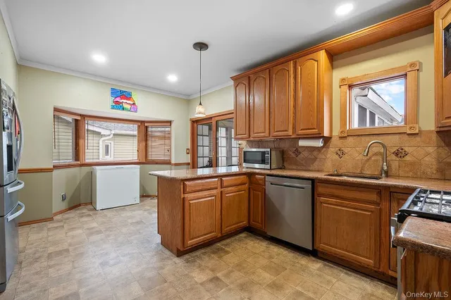 a kitchen with stainless steel appliances granite countertop a sink and cabinets