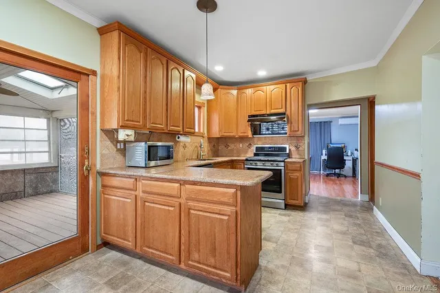 a kitchen with kitchen island granite countertop a stove cabinets and refrigerator
