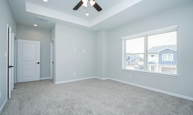 an empty room with a empty space and a ceiling fan