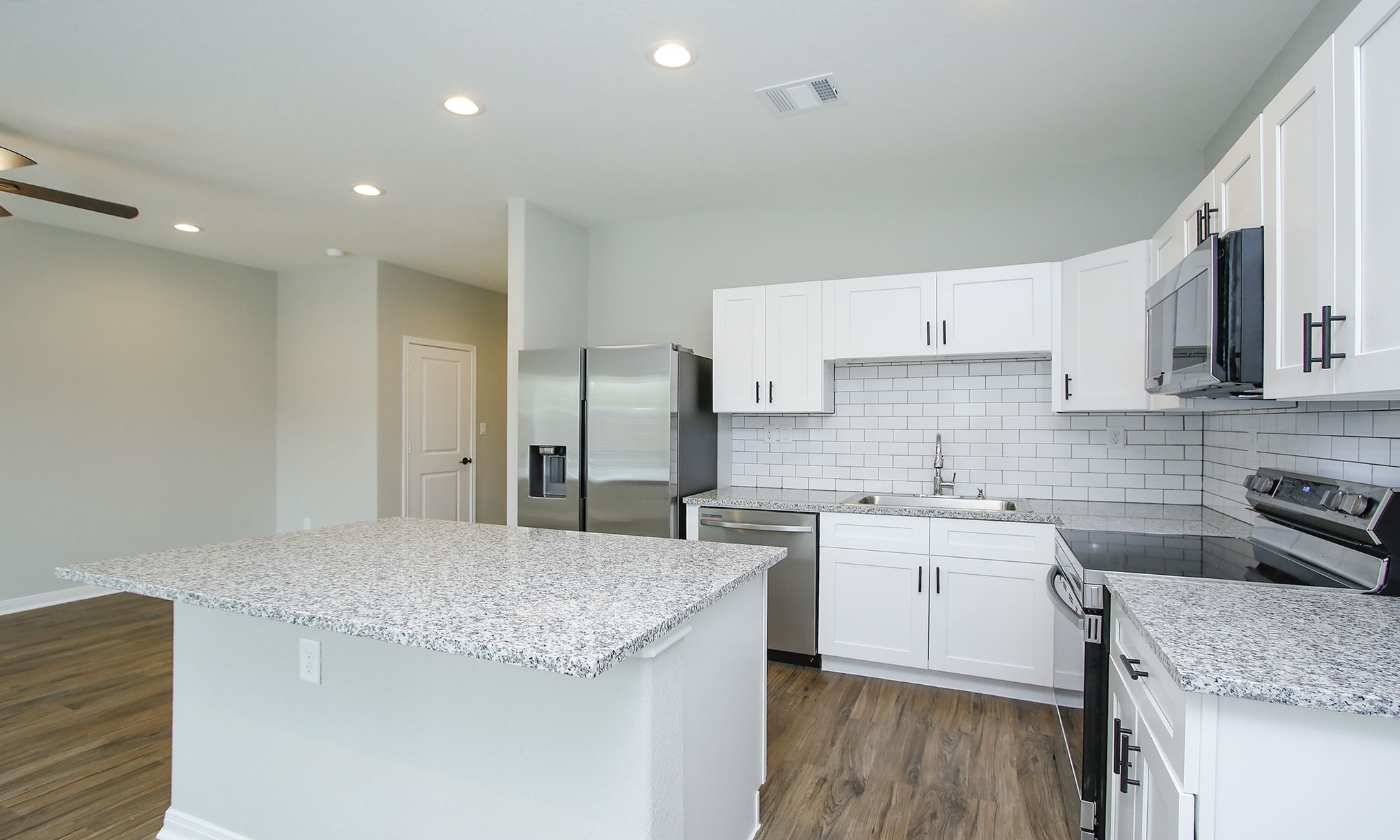 14010 Longstreet Road Willis, TX 77318 - Photo 9 of 32 a kitchen with a sink stove and refrigerator