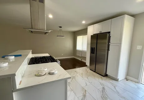 a kitchen with stainless steel appliances a refrigerator and a stove