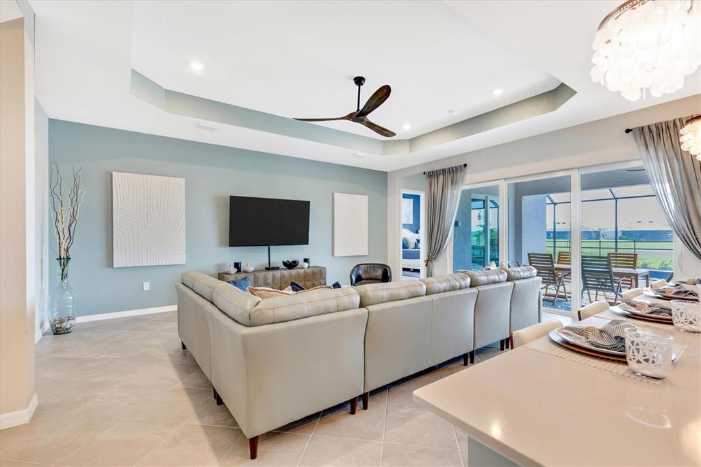 12736 Tulum Loop Venice, FL 34293 - Photo 16 of 93 a living room with furniture and a flat screen tv