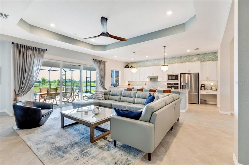 12736 Tulum Loop Venice, FL 34293 - Photo 18 of 93 a living room with furniture kitchen view and a large window