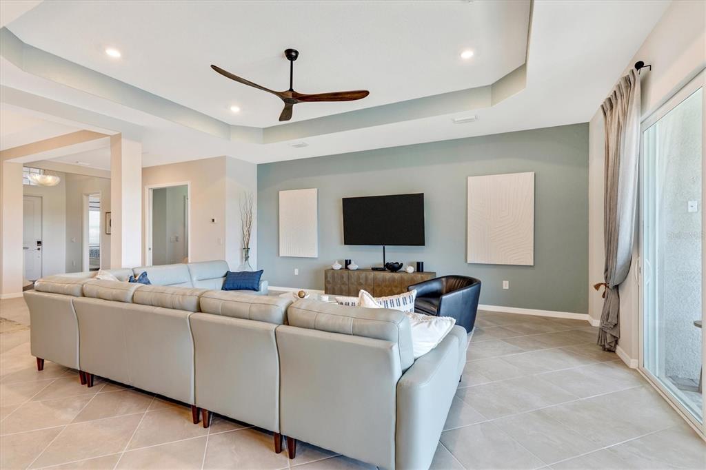 12736 Tulum Loop Venice, FL 34293 - Photo 21 of 93 a living room with furniture and a flat screen tv