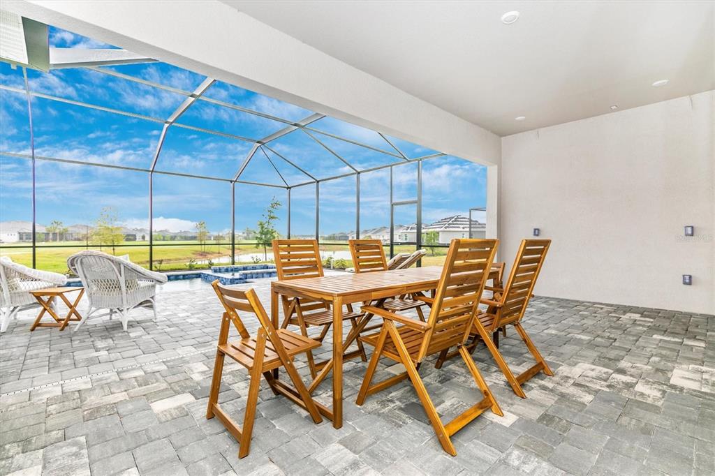 12736 Tulum Loop Venice, FL 34293 - Photo 27 of 93 a patio with a table and chairs
