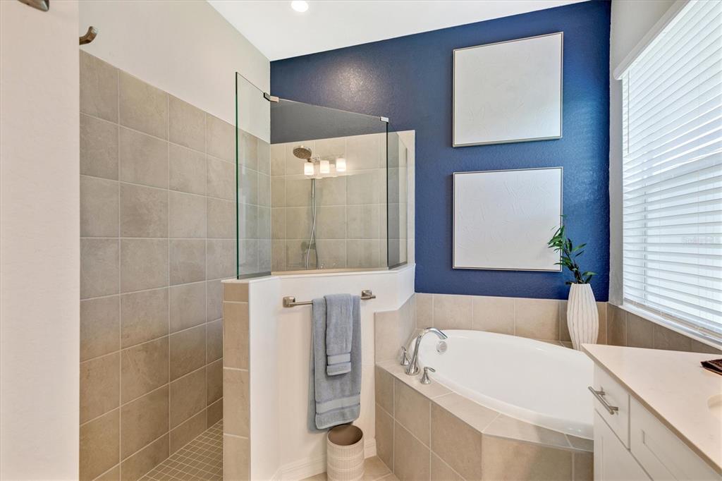 12736 Tulum Loop Venice, FL 34293 - Photo 33 of 93 a bathroom with a tub a sink and a large mirror