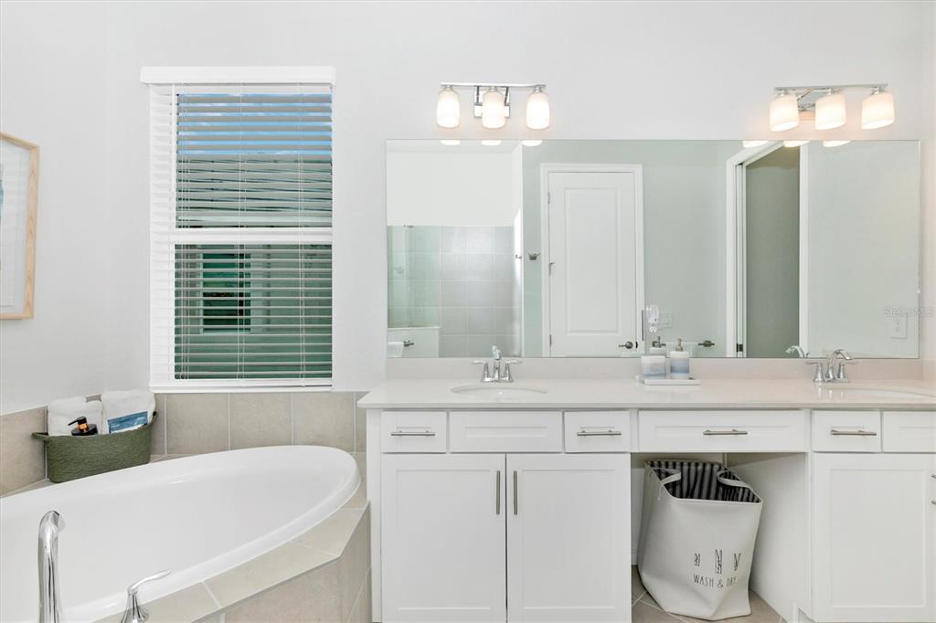 12736 Tulum Loop Venice, FL 34293 - Photo 34 of 93 a bathroom with a sink double vanity and a mirror