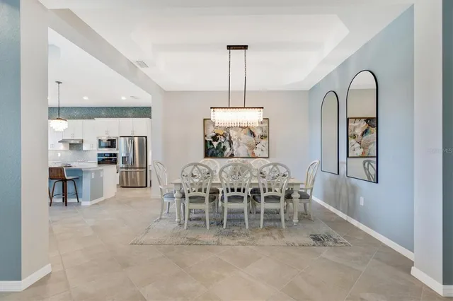 a kitchen with a sink and a chandelier