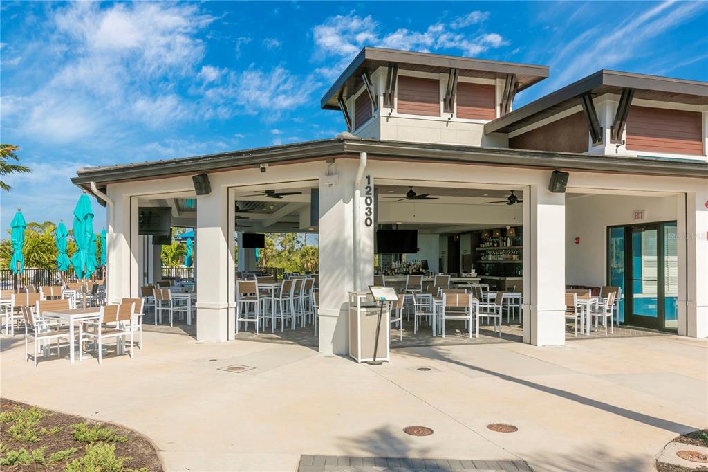 12736 Tulum Loop Venice, FL 34293 - Photo 70 of 93 a front view of a house with glass windows and furniture