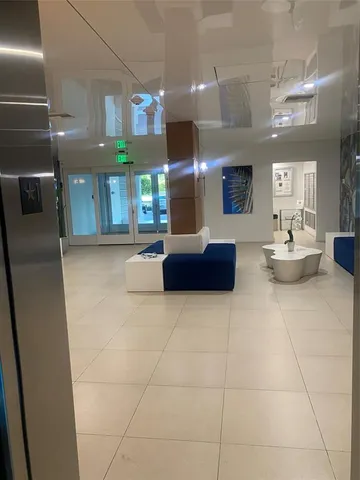 a lobby with furniture and a potted plant