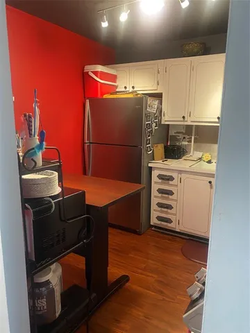 a kitchen with stainless steel appliances a stove a refrigerator and cabinets