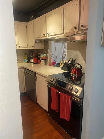 a kitchen with stainless steel appliances granite countertop a stove and a refrigerator