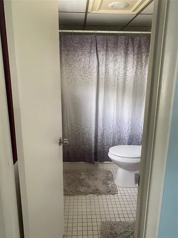 a bathroom with a shower and a toilet