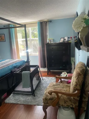 a bedroom with bed and a window