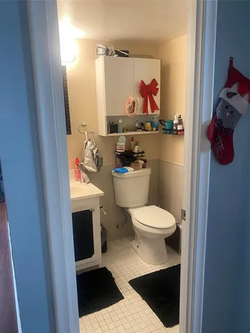 a bathroom with a toilet and a shower curtain