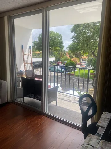 a living room with couch and a floor to ceiling window