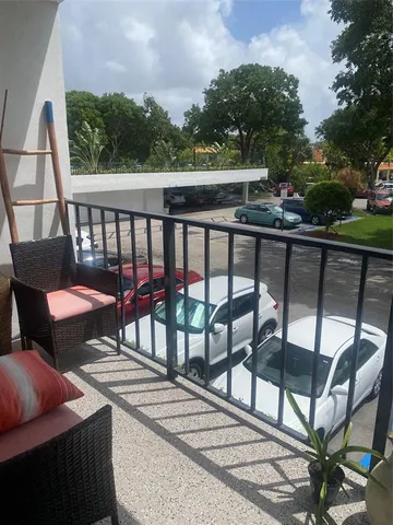 a view of a balcony with furniture