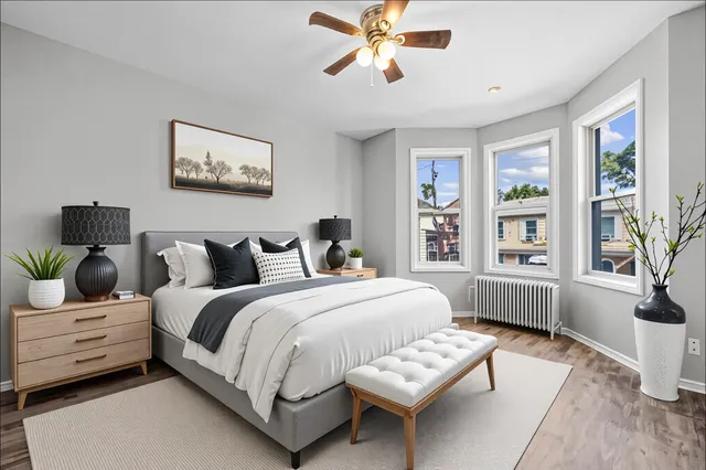 a bedroom with bed and wooden floor