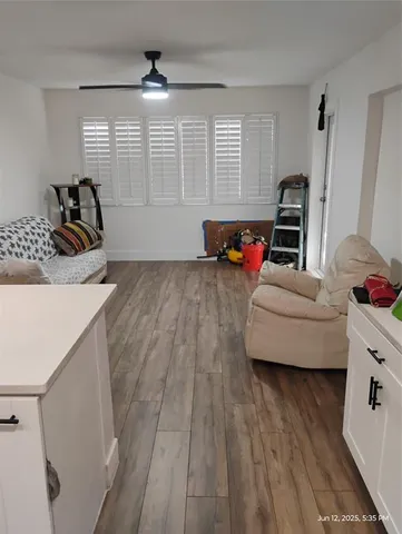 a view of a backyard with table and chairs wooden fence