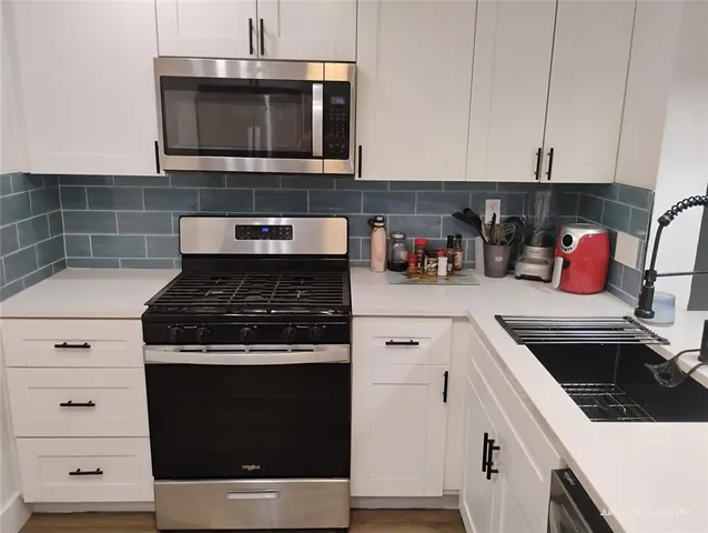 a kitchen with a stove and a microwave