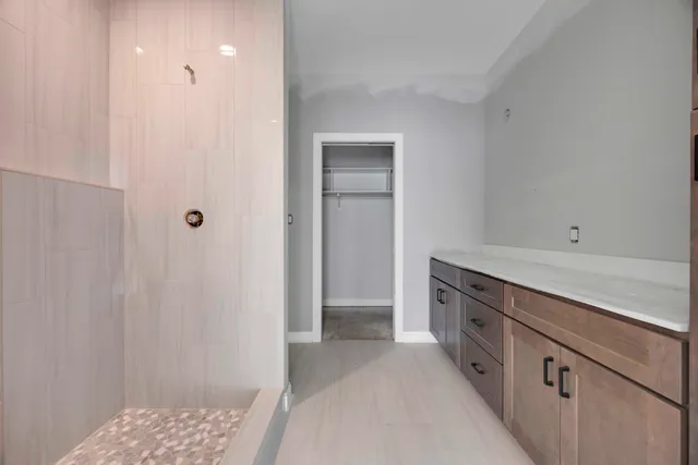 a view of a kitchen with white cabinets