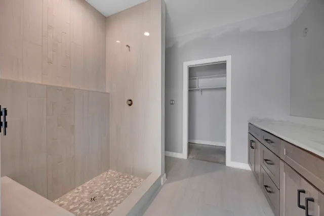 a view of a kitchen with white cabinets and wooden floor