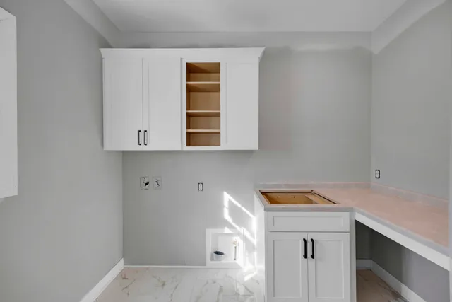 a view of utility room with two washing machine