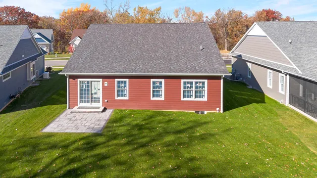 a aerial view of a house next to a big yard and large trees