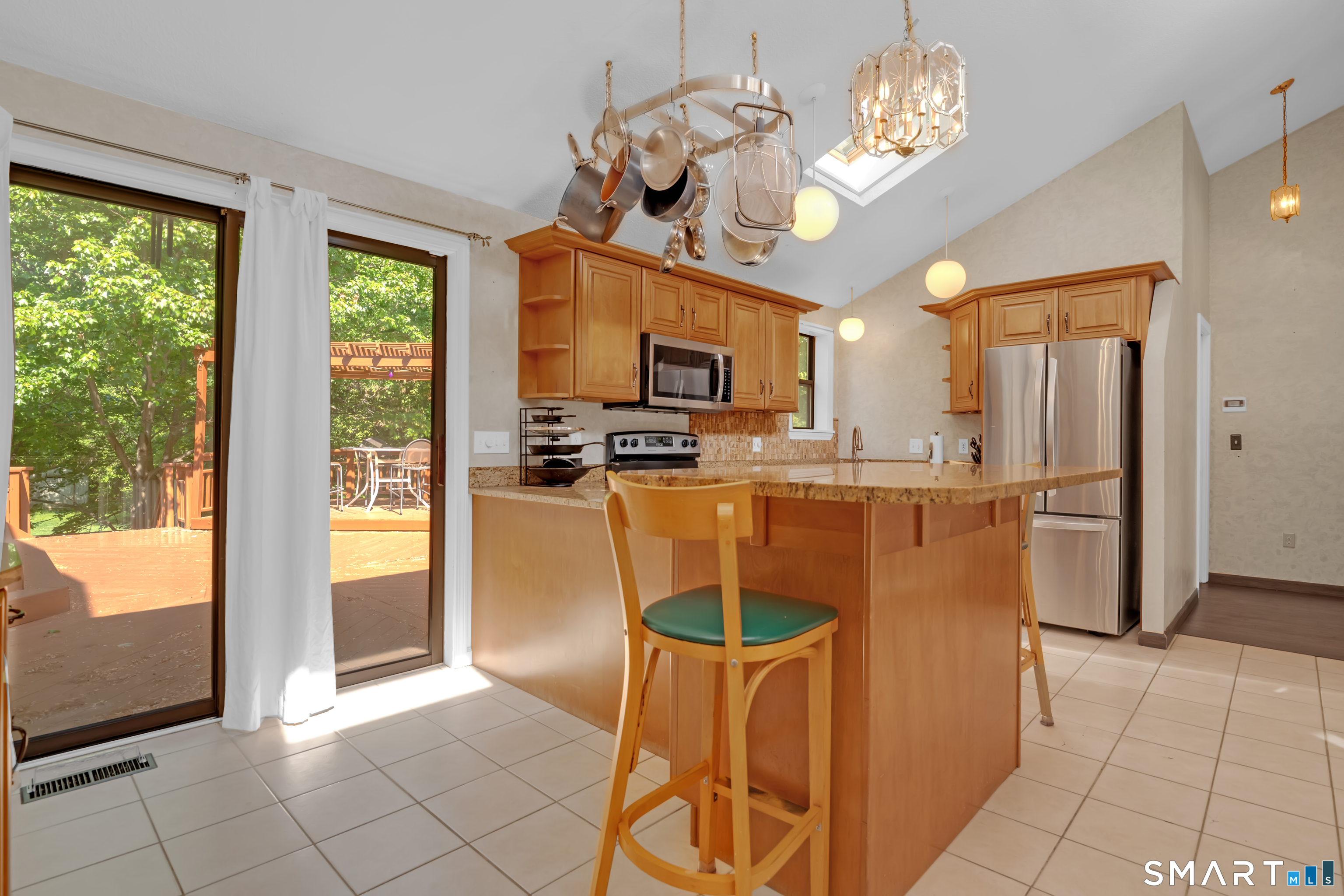 90 Bell Street Manchester, CT 06040 - Photo 7 of 40 a kitchen with stainless steel appliances granite countertop a refrigerator a oven a sink dishwasher and a dining table with wooden floor