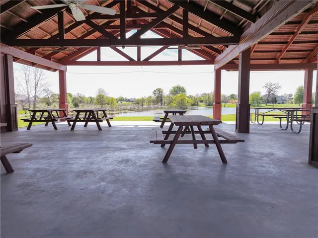 a view of a swimming pool with a patio and a backyard of a house
