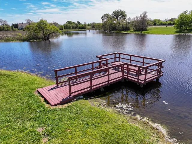a view of a wooden deck with lake view
