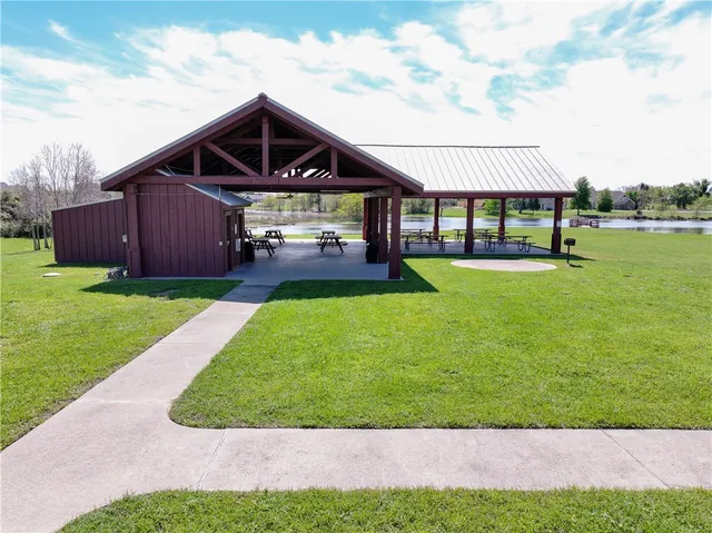 a view of a house with a yard and sitting area