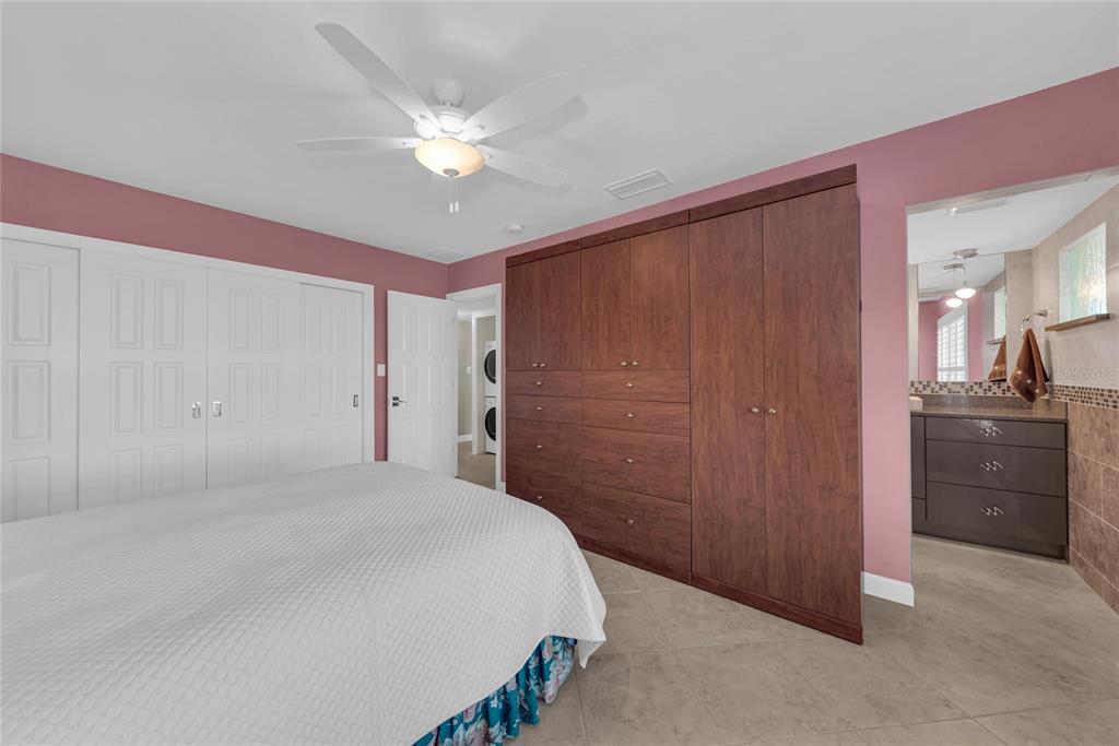 4420 Exeter Drive, Unit 307 Longboat Key, FL 34228 - Photo 13 of 37 a bedroom with a bed and a chandelier